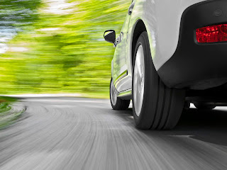 Low angle shot from the back of a car driving fast in a curveFor more car and driving images see my portfolio