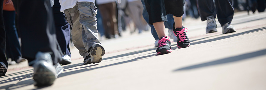 walkers on a busy sidewalk